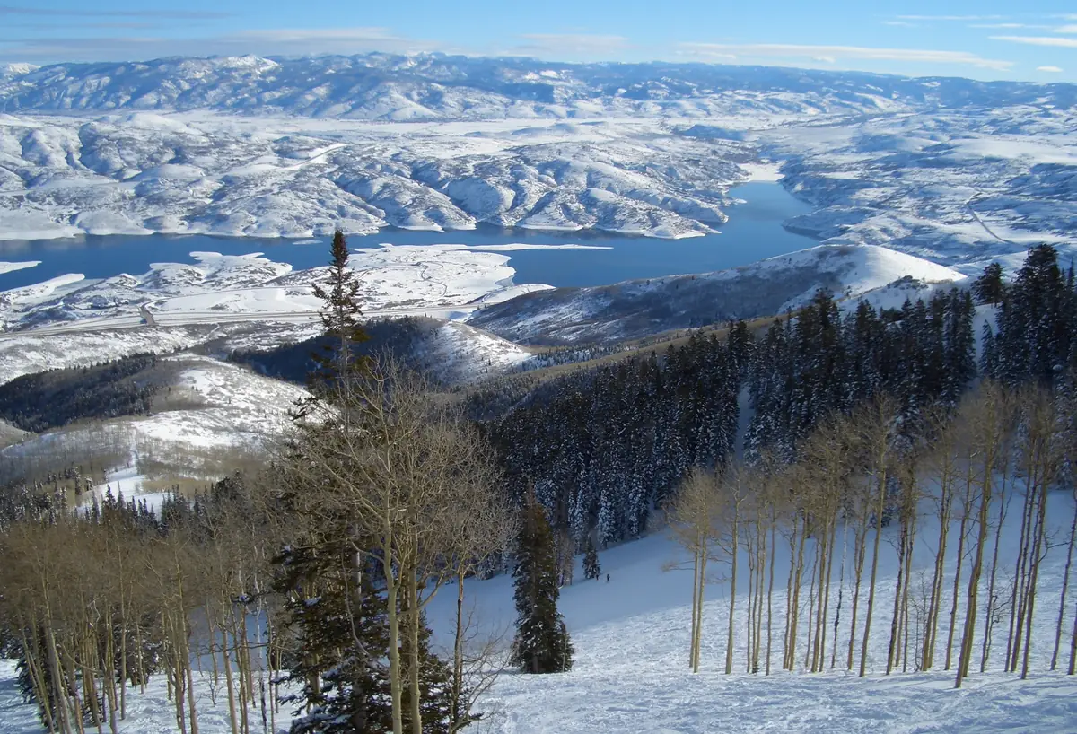 Snowy aspen slopes at Deer Valley with Jordanelle Reservoir in the distance